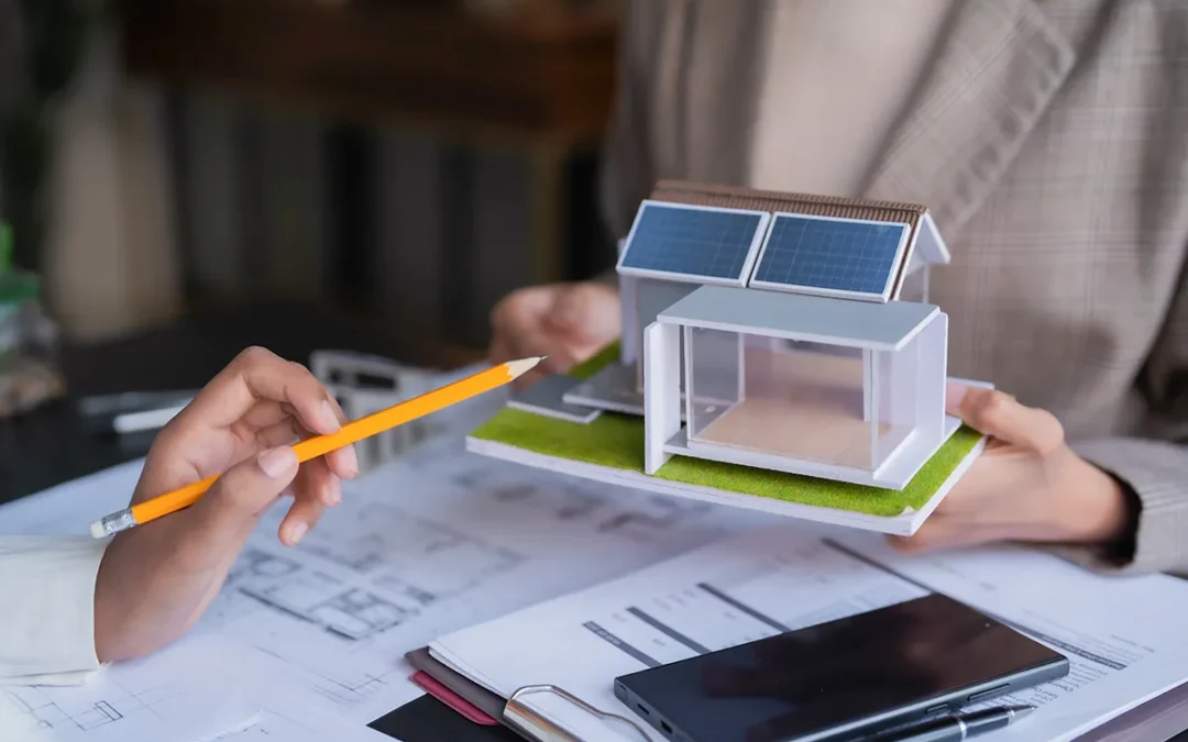 Arquitectos con modelo de casa pasiva en maqueta
